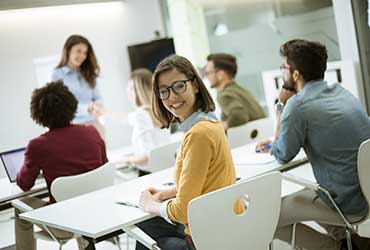 young-female-student-with-eyeglasses-in-the-class